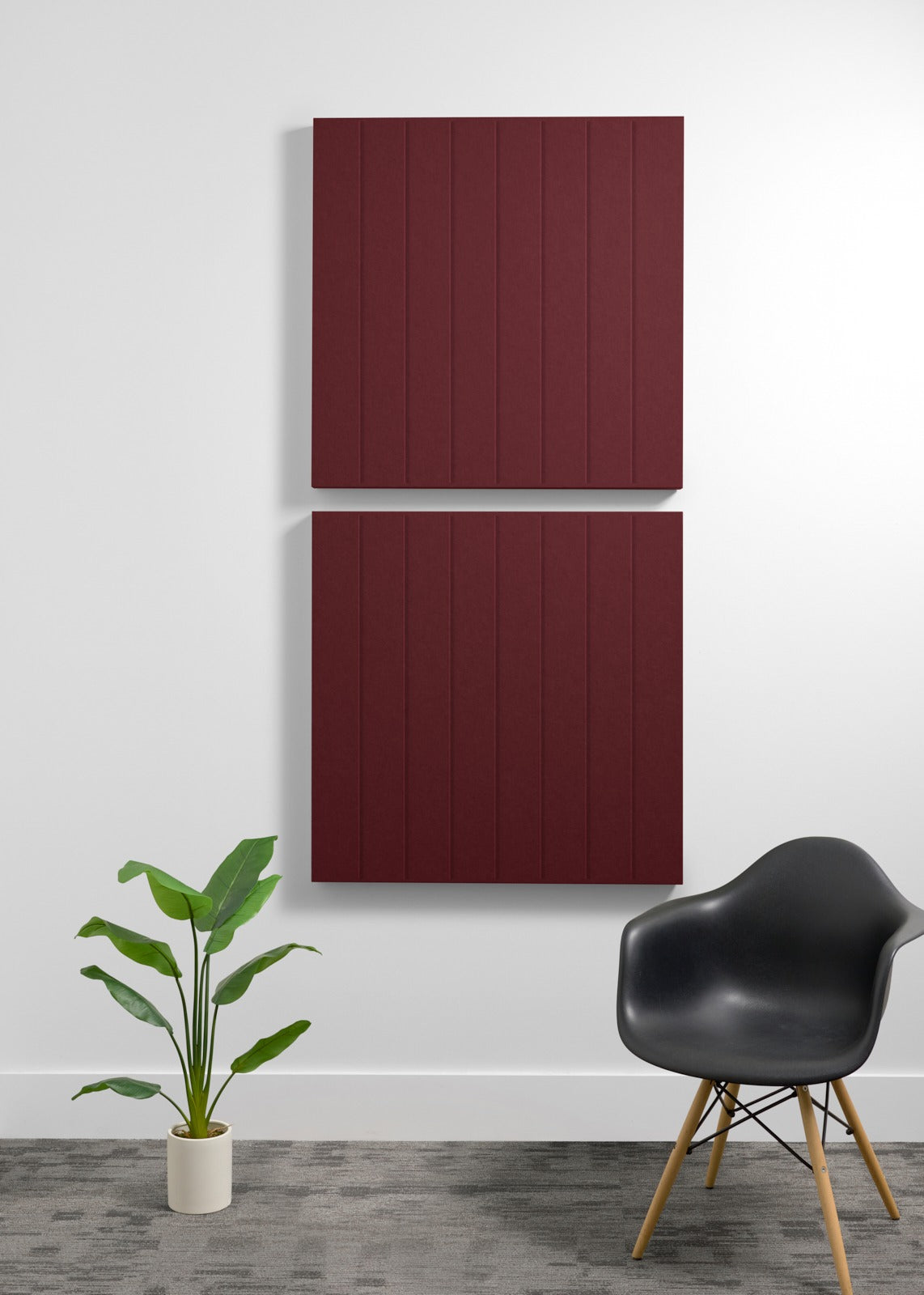 Two stacked burgundy 3D acoustic wall panels with vertical ribbed texture mounted on a wall.
