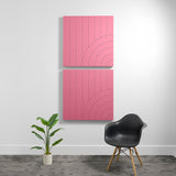 Two pink acoustic panels with vertical lines and curved geometric engravings mounted on wall.