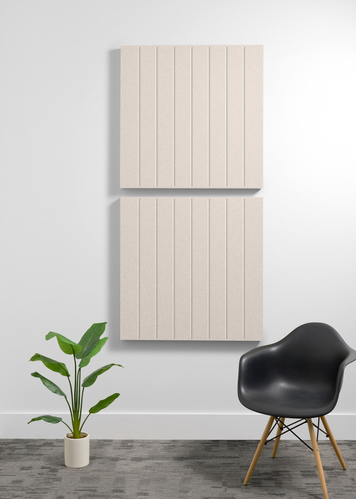 Two large beige acoustic wall panels with vertical grooves mounted vertically on a wall.