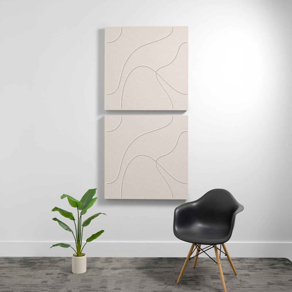Two stacked beige acoustic panels with engraved topographic line patterns mounted on white wall.
