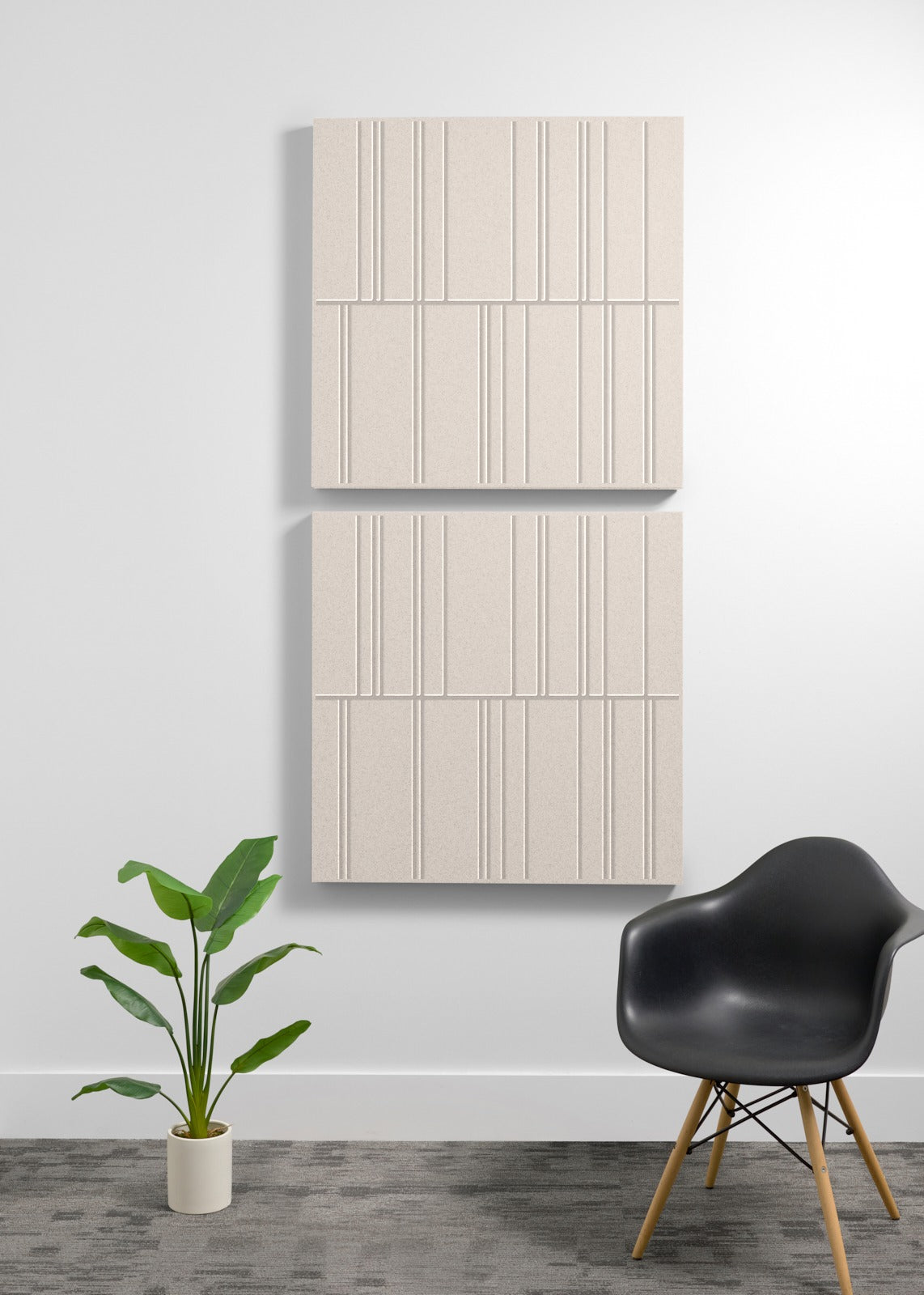 Two large beige acoustic panels with vertical line engravings mounted vertically on a wall.