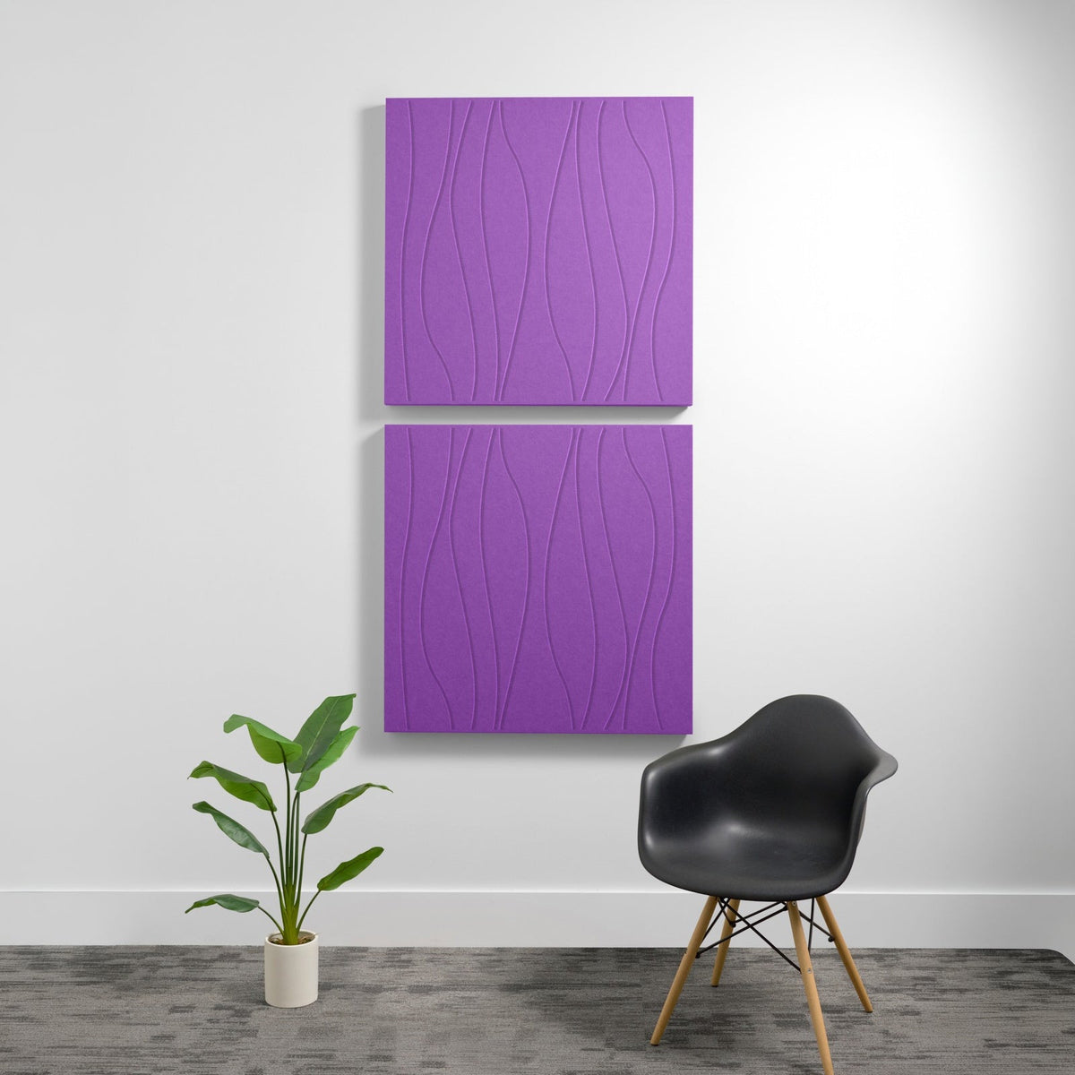 Two stacked purple acoustic panels with engraved wavy line pattern mounted on white wall.
