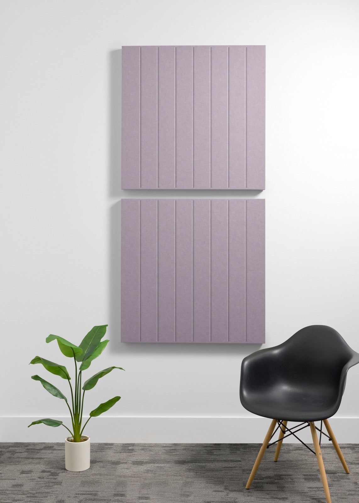 Two large mauve acoustic panels with vertical ribbed texture mounted on white wall above black chair.