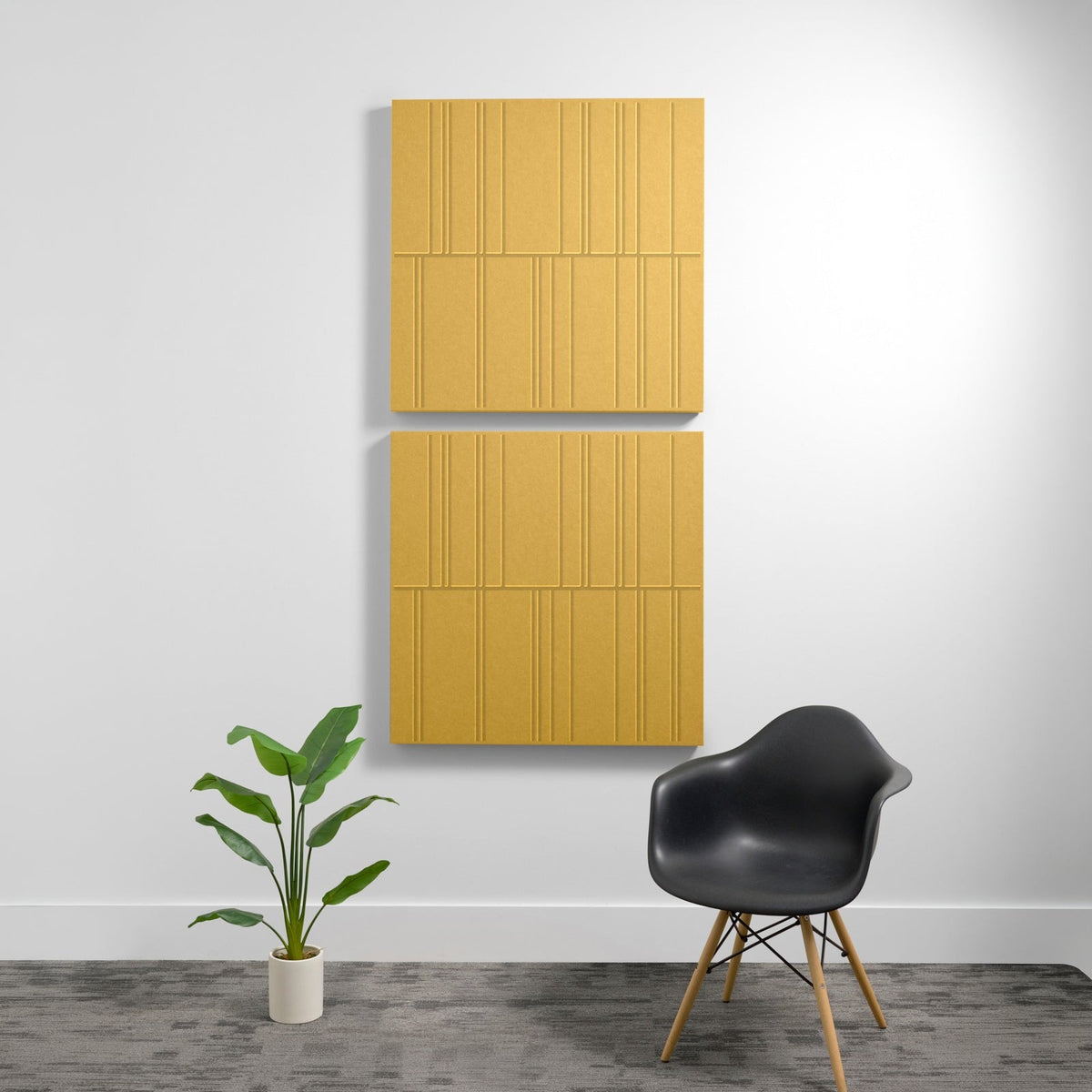 Two stacked gold acoustic panels with engraved linear box pattern mounted on white wall.