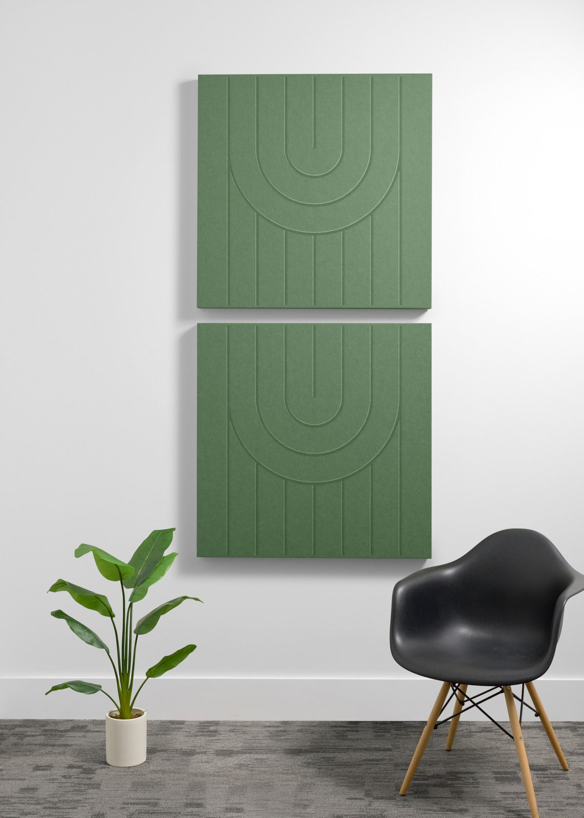 Two stacked sage green acoustic panels with engraved arc designs and vertical line detailing mounted on wall.