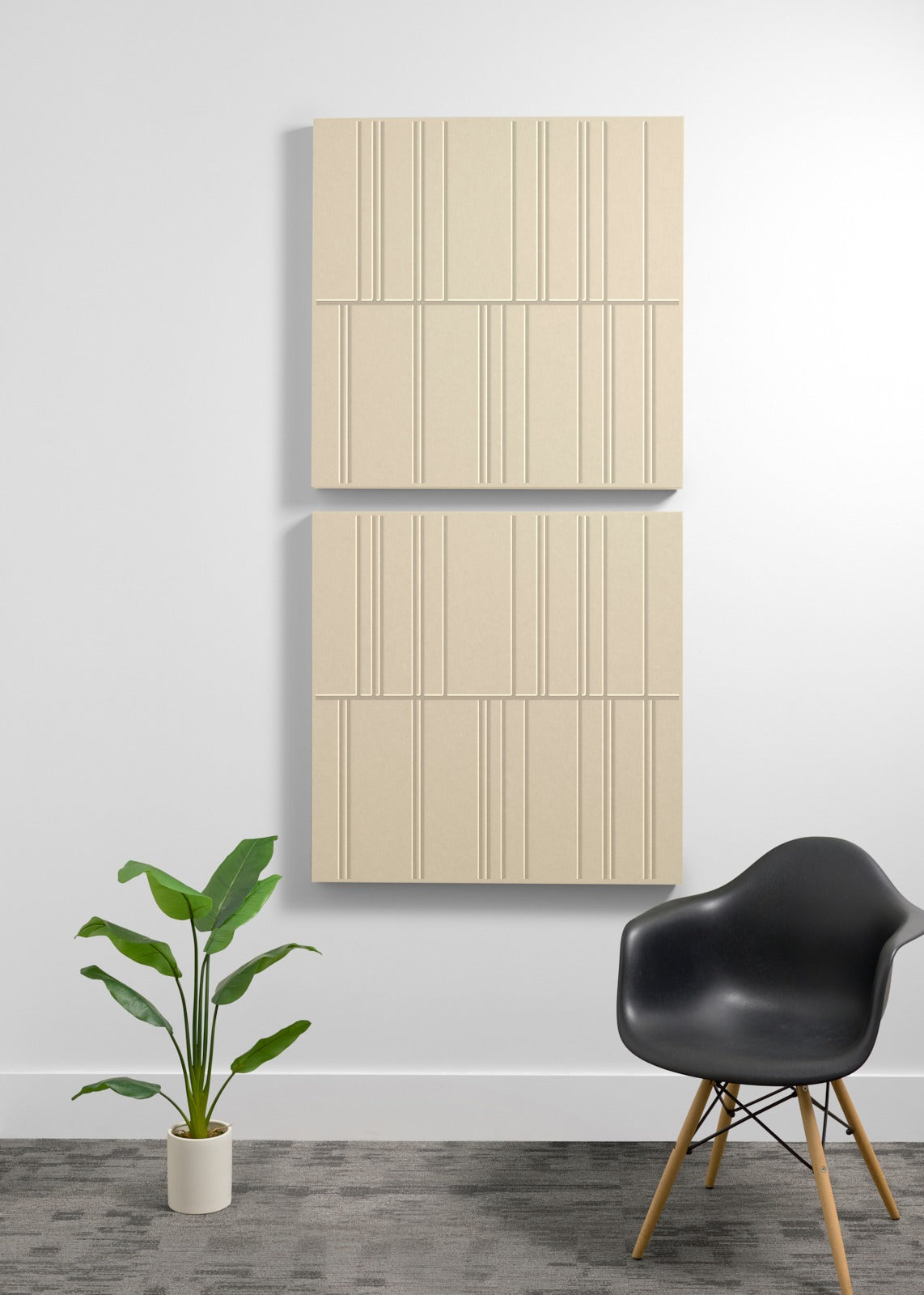 Three stacked beige acoustic panels with engraved vertical line patterns mounted on a white wall.