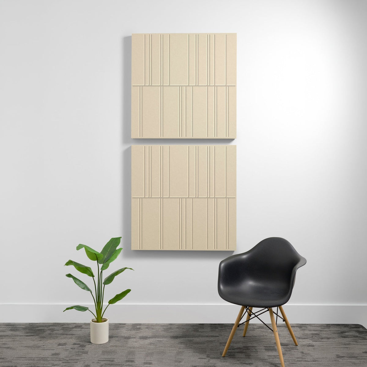 Two stacked beige acoustic wall panels with engraved linear pattern detail mounted on white wall.