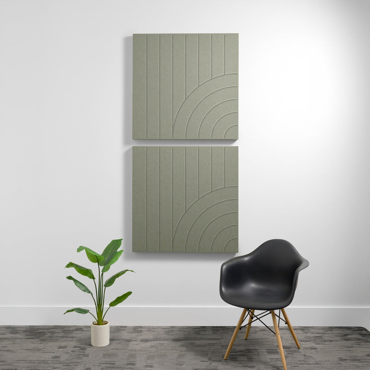 Two stacked sage green acoustic panels with vertical lines and curved arc engravings on a white wall.
