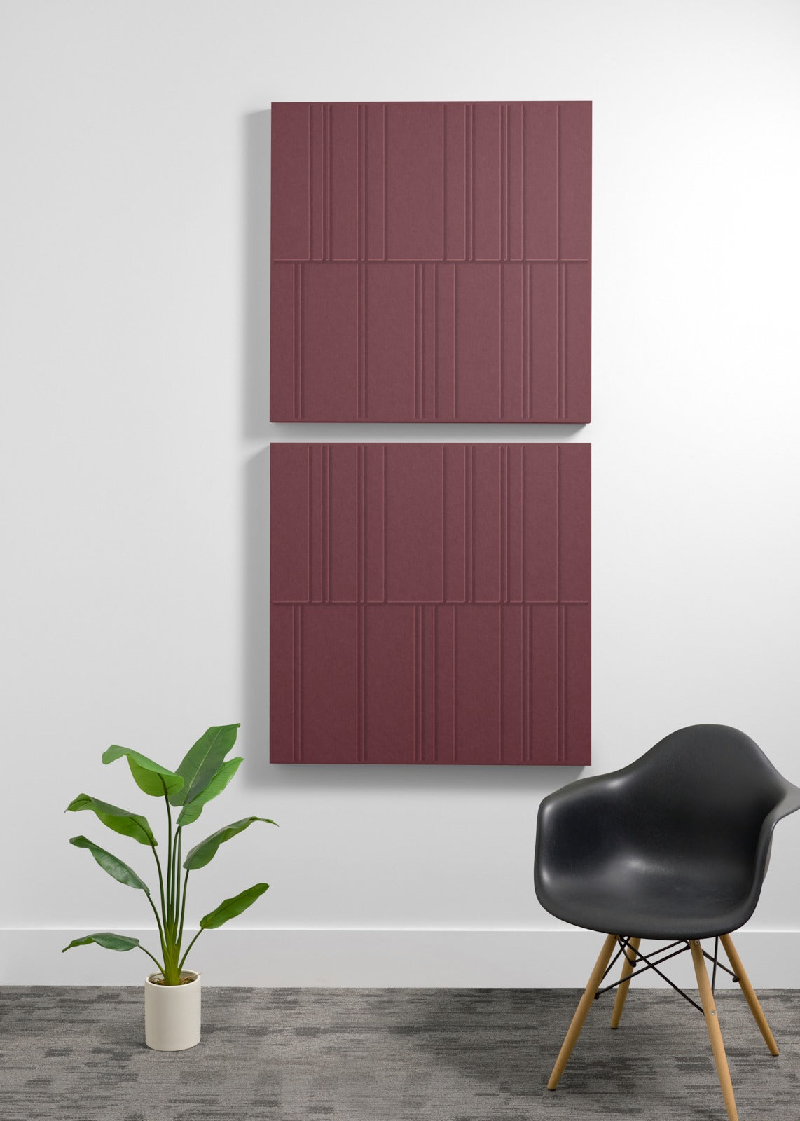 Three burgundy acoustic wall panels with linear engraved pattern mounted vertically on white wall.
