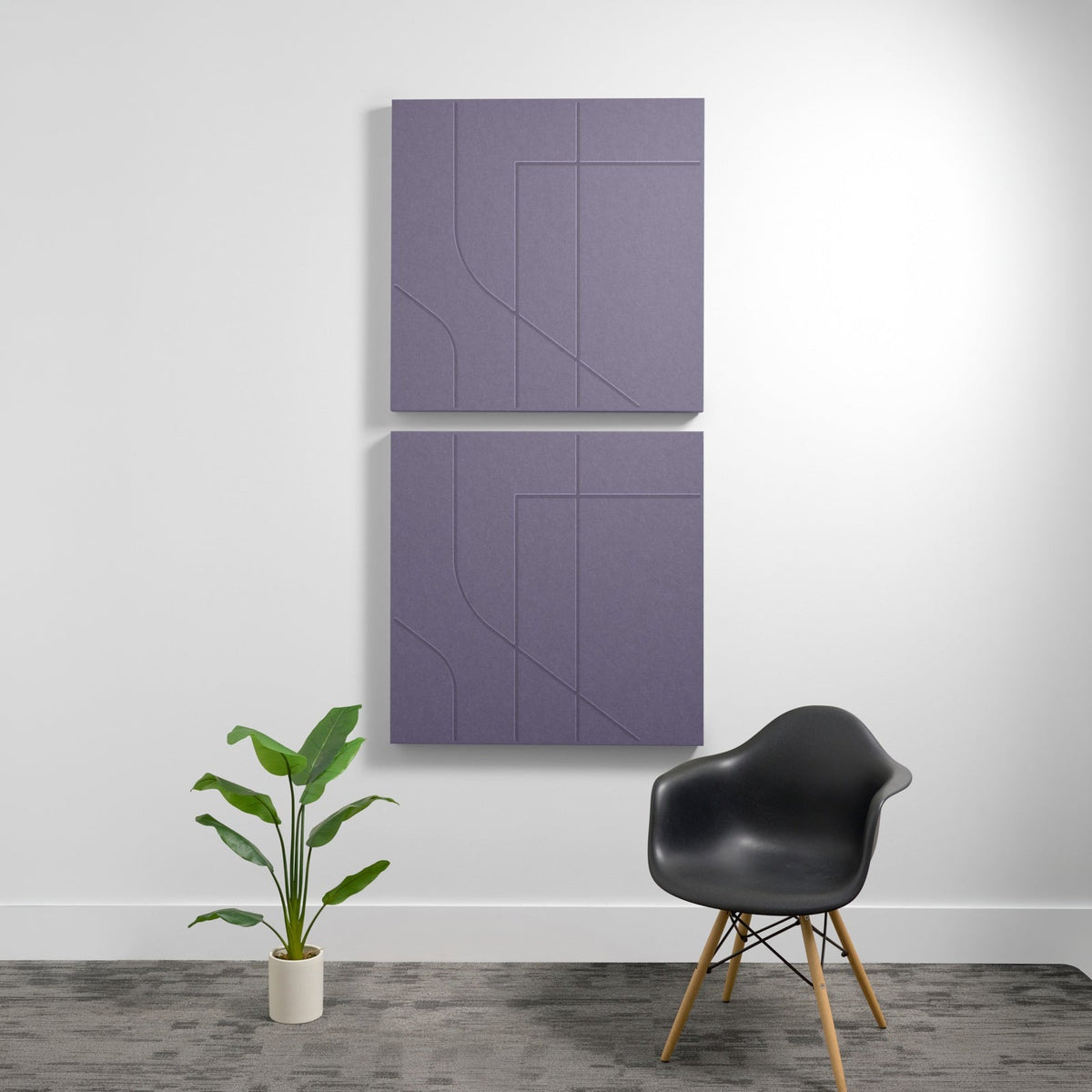 Two stacked purple acoustic wall panels with geometric engraved line patterns, mounted on white wall above black chair and po