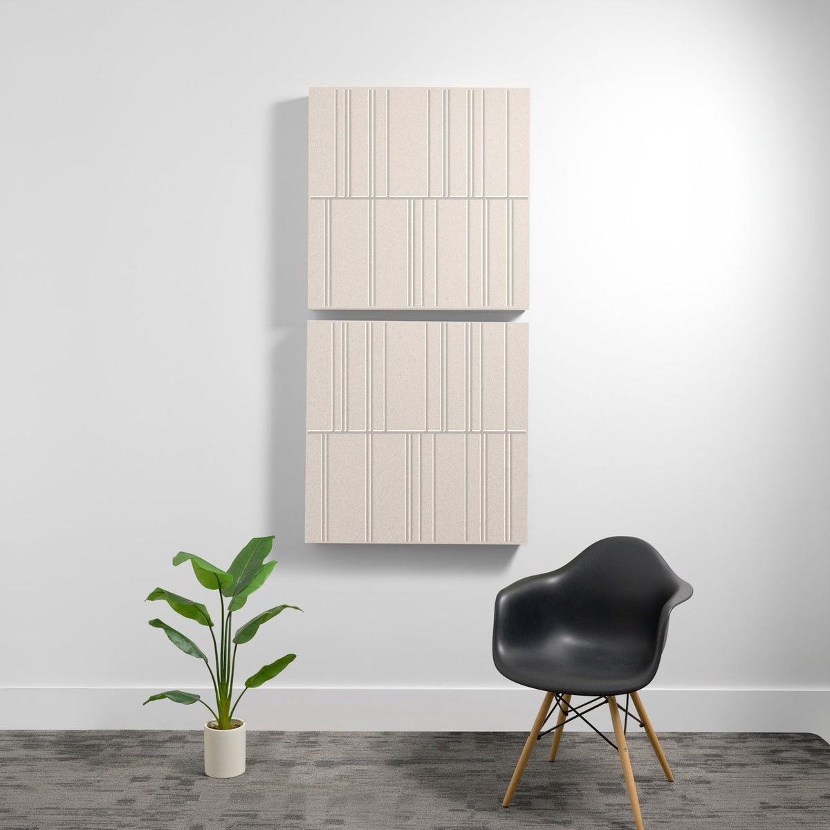 Cream-colored acoustic wall panels with vertical engraved line patterns arranged in four sections on white wall.