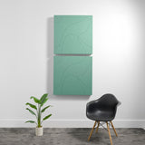 Two stacked sage green acoustic panels with topographic line engravings mounted on white wall.