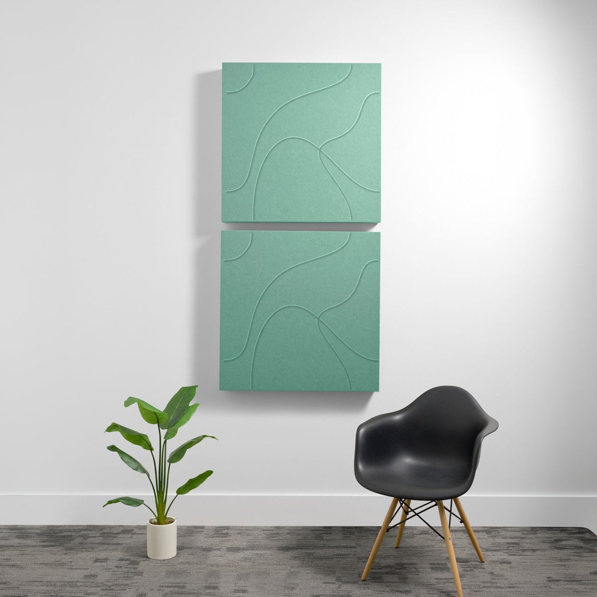 Two stacked sage green acoustic panels with topographic line engravings mounted on white wall.