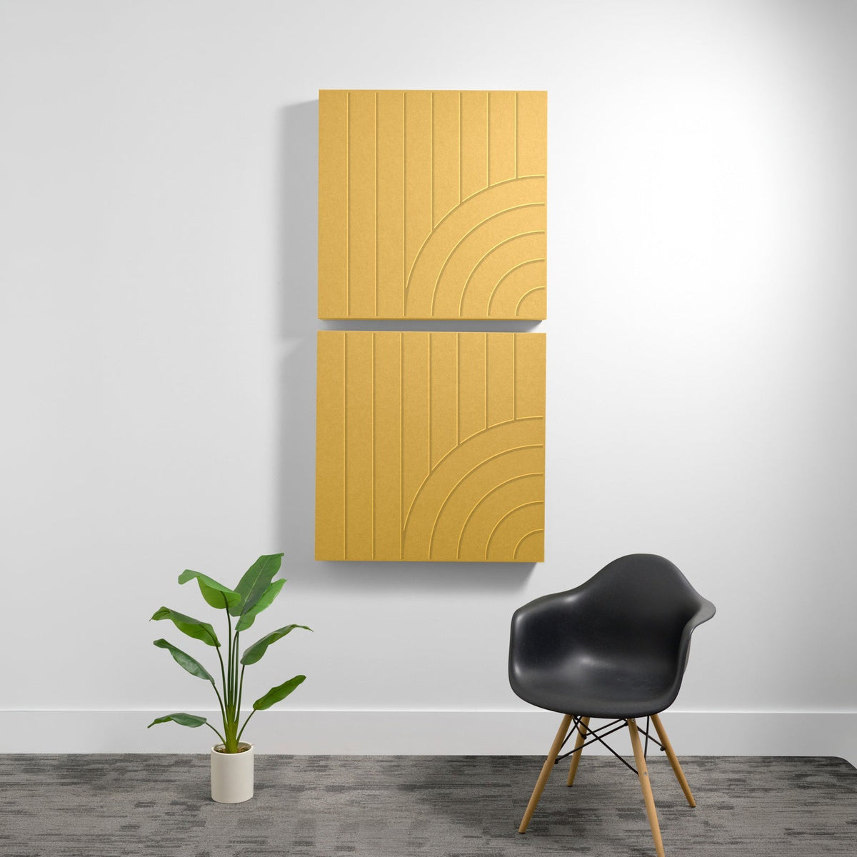 Two stacked golden wood acoustic panels with vertical lines and engraved arc patterns mounted on wall.