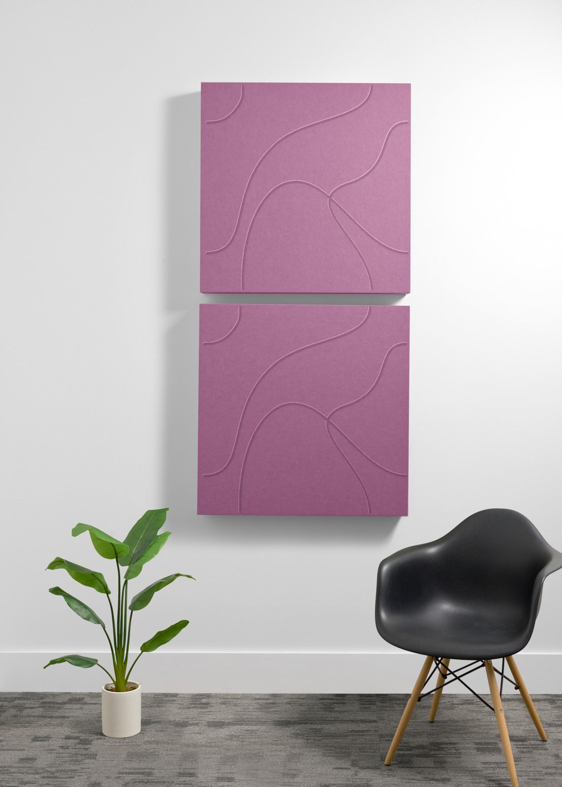 Two stacked mauve square acoustic panels with engraved topographic line patterns mounted on a white wall.