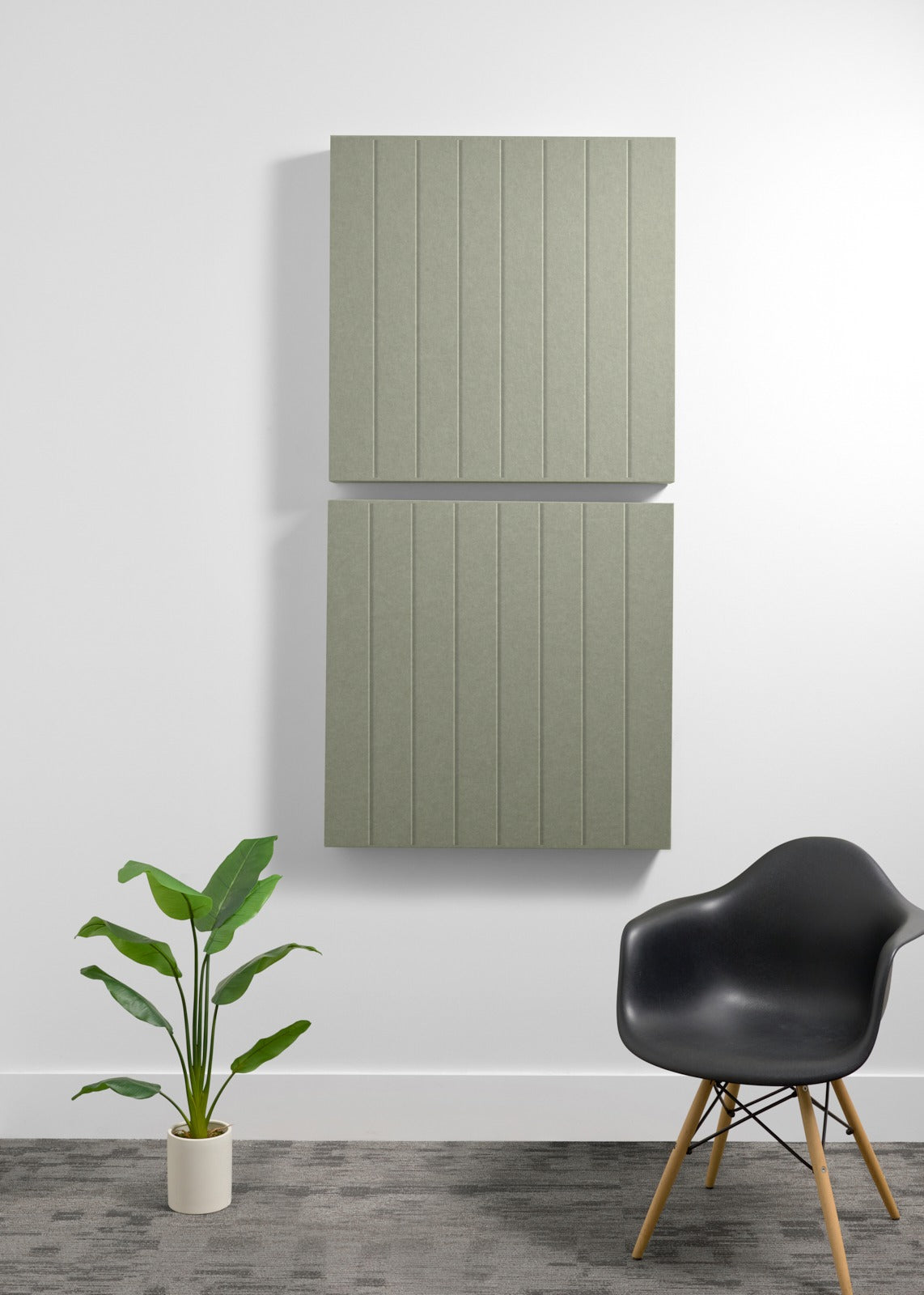 Two stacked sage green acoustic panels with parallel vertical engravings mounted on white wall.