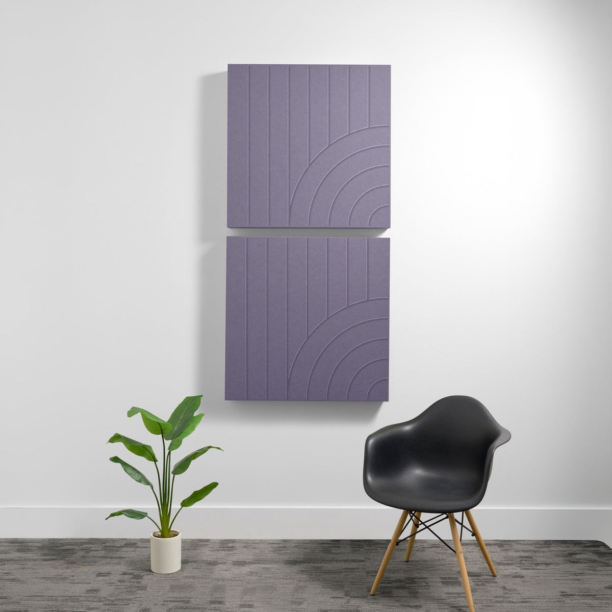 Two stacked purple acoustic panels with vertical lines and curved geometric engravings mounted on wall.