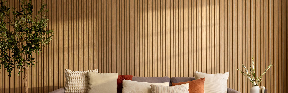 Warm wood slat panels hung wall to wall behind a couch