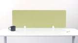 Sage green rectangular desk divider with white mounting brackets on white desk.