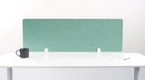 Teal fabric desk divider with white mounting brackets on white desk surface.