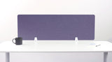 Purple desk divider panel with white mounting brackets positioned on white desk surface.