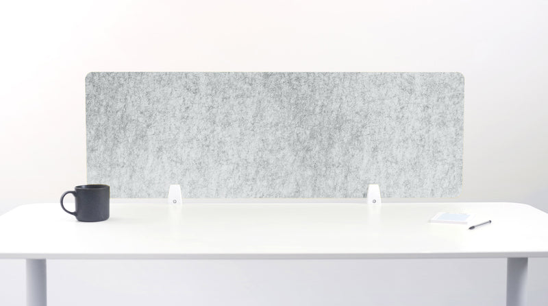 Gray office partition screen on a white desk with a black mug and pen.