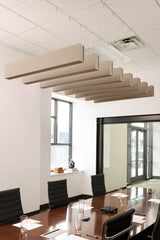 Beige felt acoustic beams suspended from ceiling in staggered arrangement above conference table.