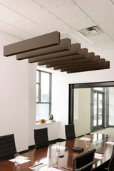 Brown felt acoustic beams suspended from white drop ceiling in modern conference room setting.