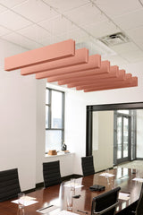 Salmon pink felt acoustic beams suspended horizontally from drop ceiling in office meeting room.