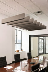 Multiple wood grain acoustic beams suspended horizontally from drop ceiling in conference room above table.