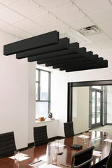 Black felt acoustic beams suspended horizontally from ceiling in office conference room.
