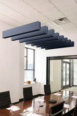 Seven blue-gray felt acoustic beams suspended horizontally from white ceiling in staggered formation above conference table.