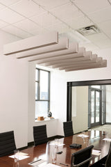 Beige felt acoustic beams suspended from drop ceiling above conference table in modern office space.