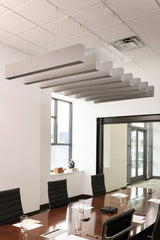 Suspended wood grain acoustic beams with dark undersides hanging from ceiling in modern office conference room.