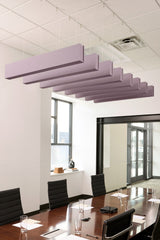 Purple felt acoustic beams suspended from drop ceiling in office conference room.