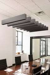Gray felt acoustic beams suspended horizontally above a conference table in an office space.