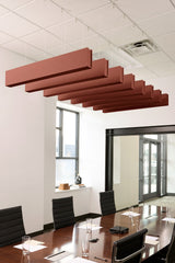 Rust-colored felt acoustic beams suspended horizontally from drop ceiling in office conference room.
