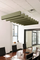 Multiple sage green felt acoustic beams suspended horizontally from ceiling in office conference room.
