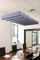 Blue-gray felt acoustic beams suspended from ceiling in staggered arrangement above conference table.