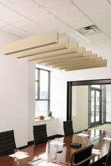 Tan felt acoustic beams suspended from ceiling above conference table in modern office space.