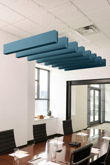 Blue felt acoustic beams suspended from ceiling above conference table in office space.