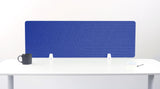 Blue desk divider with geometric line pattern, positioned on white desk with white support brackets.