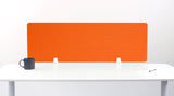 Orange desk divider with geometric line pattern, positioned on white desk with white support brackets.