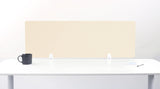 An ivory-colored felt desk divider placed on a white desk with a black mug and a pen beside it.