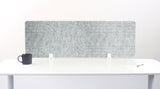 White desk with a marble-patterned screen and a black mug on a white background