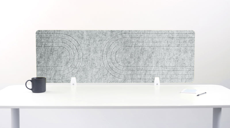 White desk with a marble-patterned screen and a black mug on a white background