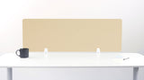 Wooden desk divider with geometric arc pattern in natural finish, mounted on white desk with black mug and supplies.