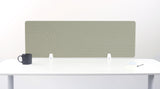 Sage green desk divider with geometric line pattern, mounted on white desk with black mug and notepad.