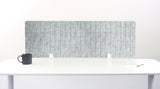 Gray textured office screen partition on a white desk with a white background