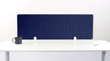 Navy blue quilted desk divider with vertical grid pattern mounted on white desk with two white brackets.